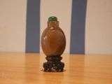 a small bottle sitting on top of a wooden table
