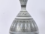 a black and white vase with geometric designs on it