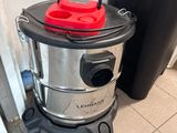 a vacuum cleaner sitting on the floor next to a trash can