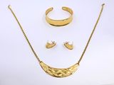 a close up of a necklace, earrings and ring on a white surface