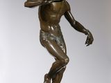 an image of a bronze statue of a man holding a baseball bat