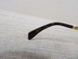 a close up of a pair of glasses laying on a pillow