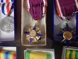 several medals and ribbons are in a box on a table