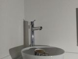 a white sink in a bathroom with a mirror above it