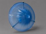 a blue glass object with a flower inside of it