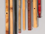 five different types of flutes lined up on a white surface
