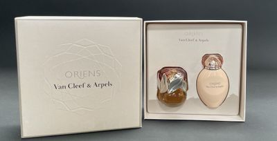 an open box with two perfume bottles in it sitting on a table