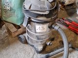 un aspirateur posé par terre à côté d'un sac