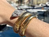 a person that has a bracelet and a ring on their wrist