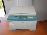 a printer that is sitting on a table in front of a window