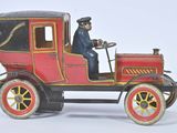 a red toy car with a man sitting in the driver ' s seat
