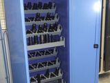 a blue cabinet with many bottles of wine in it