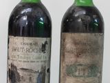 three bottles of wine sitting on top of a white table