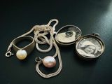 un collier orné d'une image représentant une femme et d'une perle