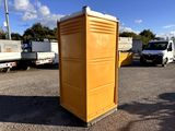 a yellow portable toilet sitting in the middle of a parking lot