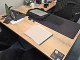 a desk with a laptop, printer, and other office supplies on it