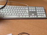 a computer keyboard and mouse sitting on a desk