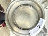 a metal bowl with a sticker on the side of it