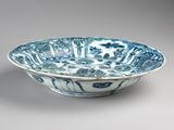 blue and white bowl with floral design on it on a gray surface