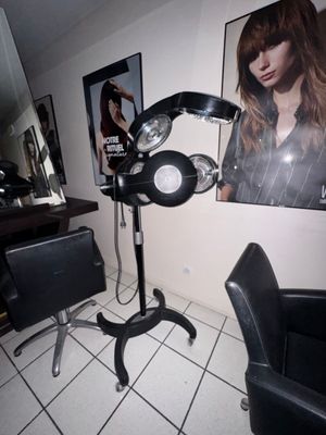 a picture of a salon with a chair and a hair dryer