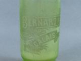 a green glass jar with a bird on it