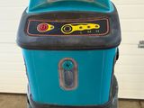 a blue machine that is sitting in a garage