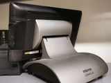 an image of a printer on a desk with a roll of paper
