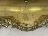 a gold clock with a bird on top of it