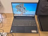 a laptop that is sitting on a desk with a bag