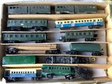 a lot of toy trains in a box on the table