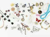 many different types of jewelry on a white surface