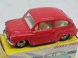 a red toy car sitting on top of a box