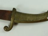 a knife that is on a table with a tag on it