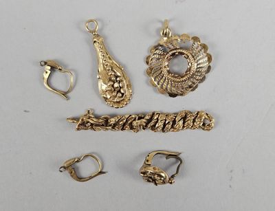 several pieces of gold jewelry are displayed on a white surface