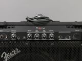 the amplifier is sitting on top of the speaker cabinet