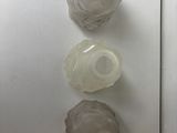three empty plastic bottles sitting on a refrigerator door