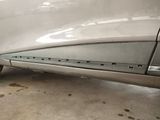 a close up of a car ' s rear end with the door open