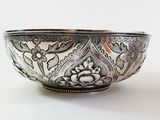 a silver bowl that is sitting on a table