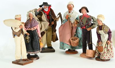 five figurines of people dressed in historical clothing
