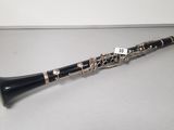 a close up of a clarinet on a table with a price tag on it