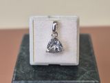 silver plated pendant with a heart shaped diamond on top of a white box