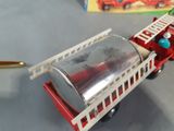 a toy fire truck with a can on the back of it
