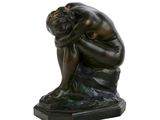 statue of a man sitting on a rock with his head in his hands