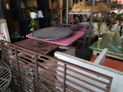 a large pile of furniture in a room with a lot of shelves