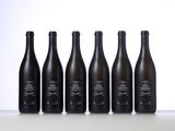 six bottles of wine lined up in a row on a table