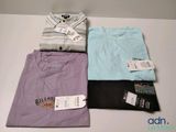 three t - shirts are sitting on a table with a price tag