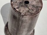 a metal object that is sitting on a white surface