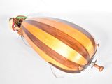 a wooden object that is sitting on a white surface