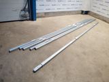 two metal bars are laying on the floor in front of a garage door