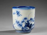 a blue and white cup sitting on a table